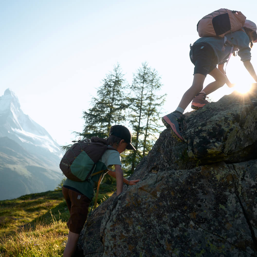 Children hiking on alpine trails with Matterhorn mountain in the background