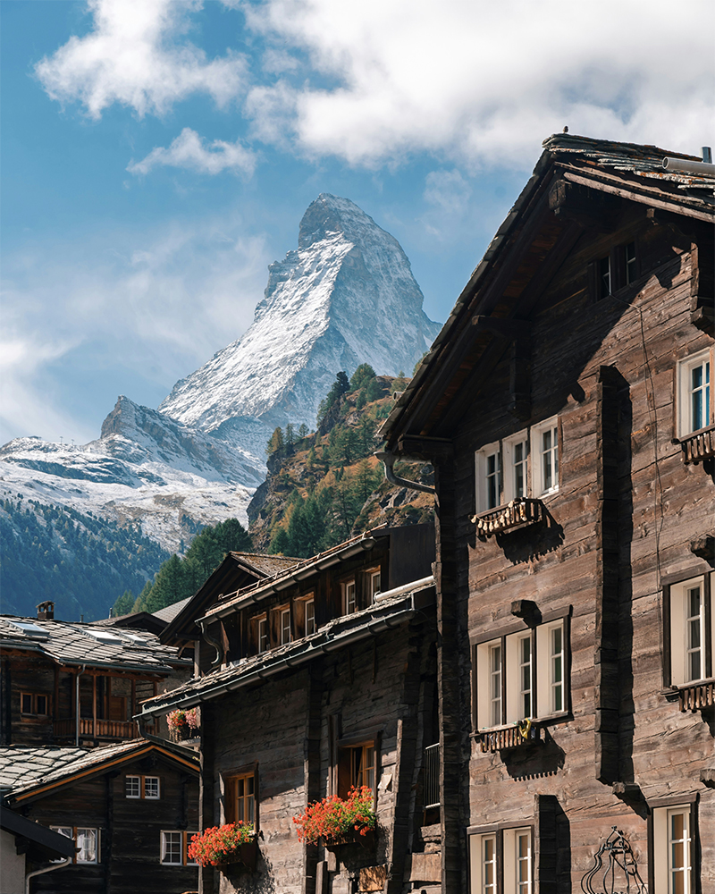 Historic wooden chalets in Zermatt with panoramic view of the Matterhorn peak