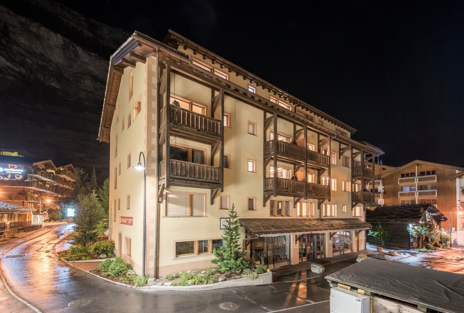 Central Zermatt holiday apartment building near train station with balconies and alpine style