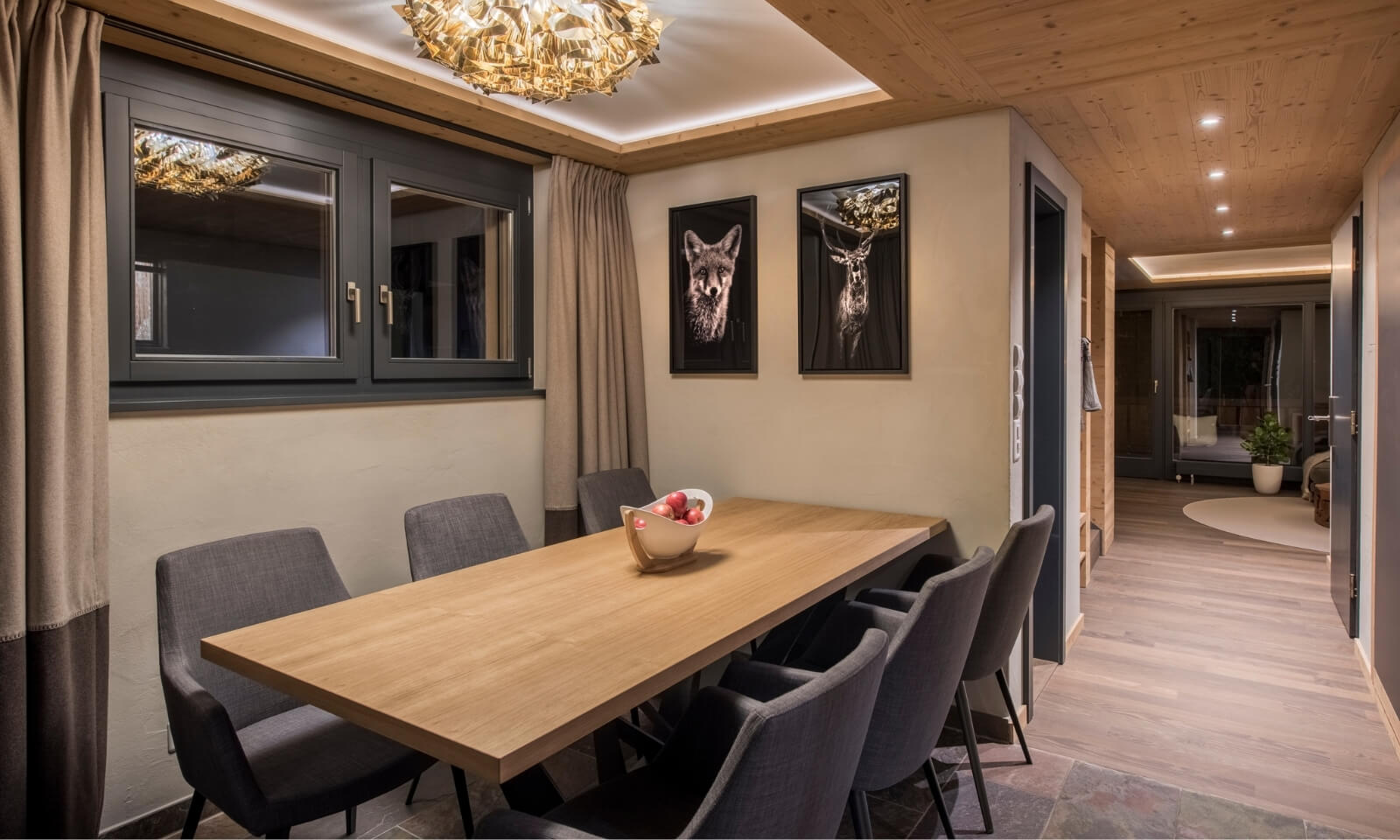 Elegant Zermatt duplex dining room with modern lighting and alpine-inspired artwork