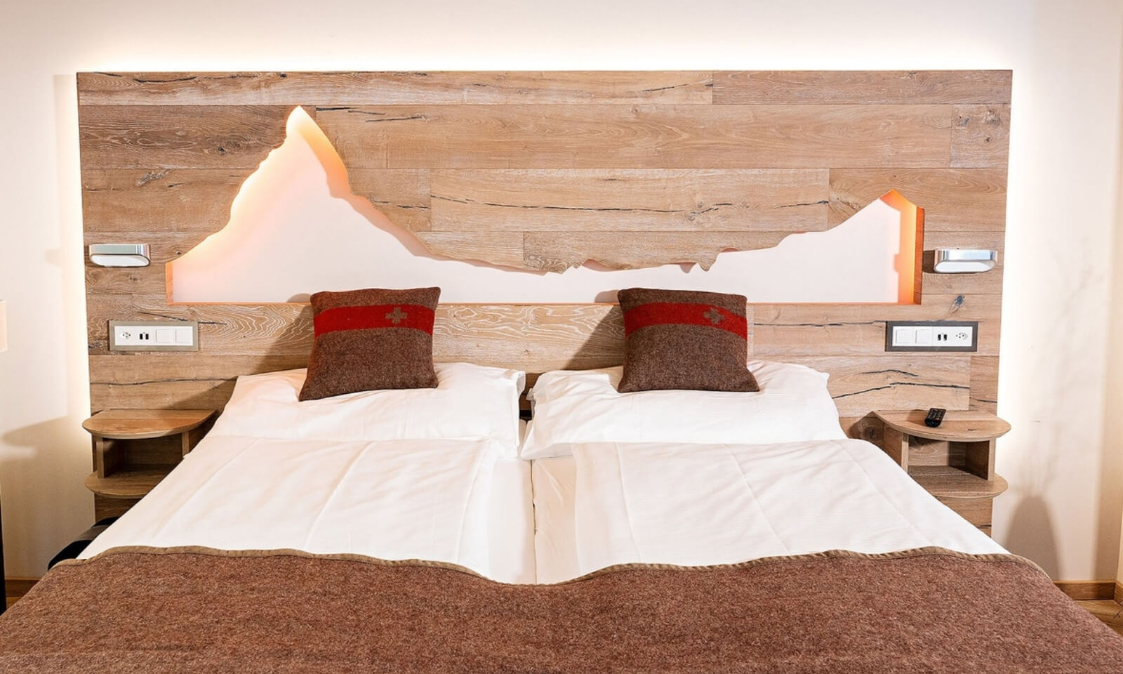 Zermatt Stays Modern Loft double bed with wooden Matterhorn headboard and cozy Swiss decor