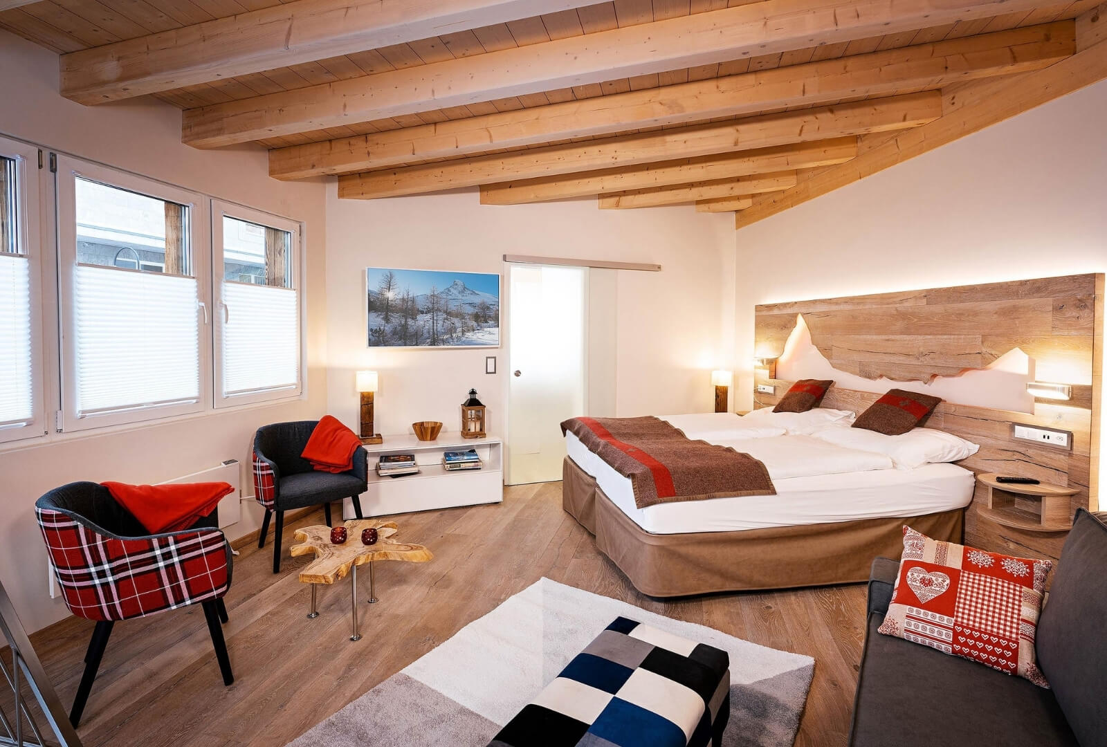 Bright Modern Loft apartment in Zermatt with wooden beams, comfortable double bed, and cozy decor
