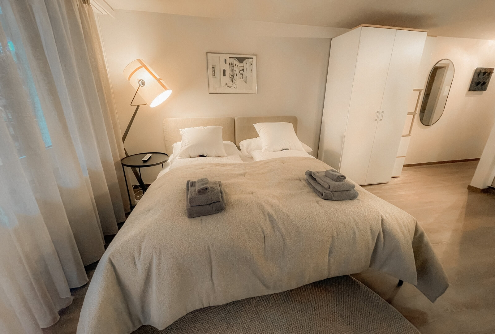 Comfortable double bed with fresh linens and wardrobe in Studio JaMi Zermatt.