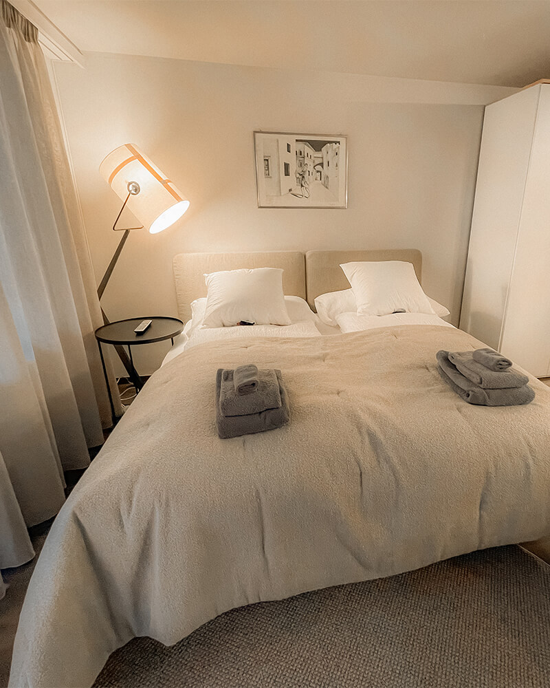 Comfortable Zermatt holiday apartment bedroom with double bed and soft lighting