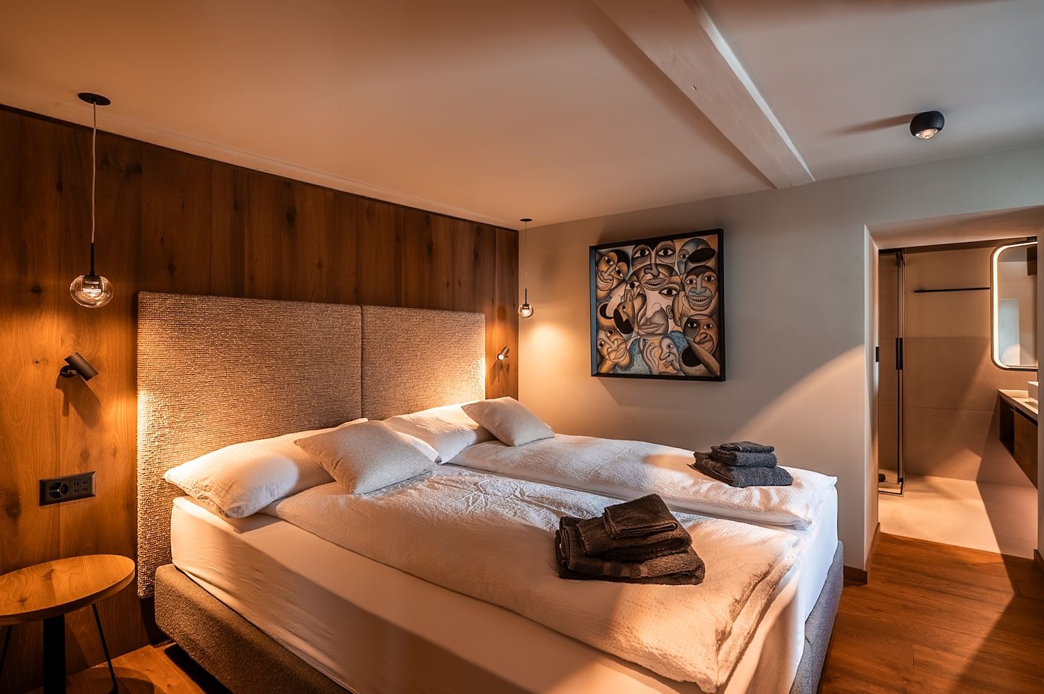 Comfortable bedroom with warm wood paneling and soft lighting in the "Zermatt Stays" holiday home