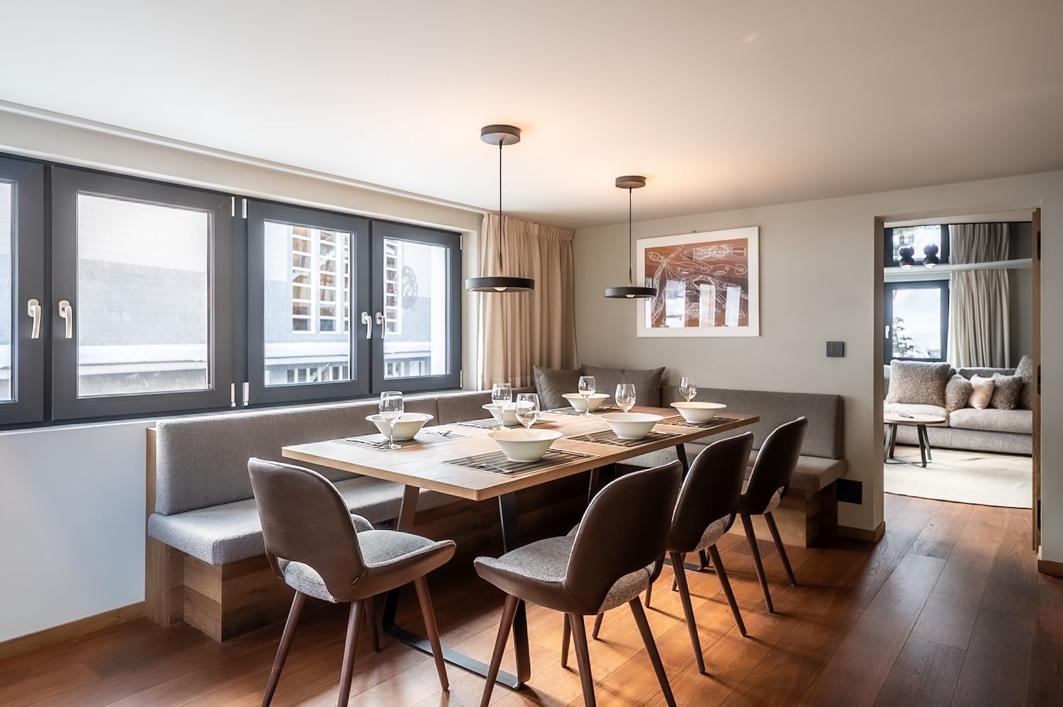 Elegant dining area with large windows and comfortable seating at the "Zermatt Stays" holiday home